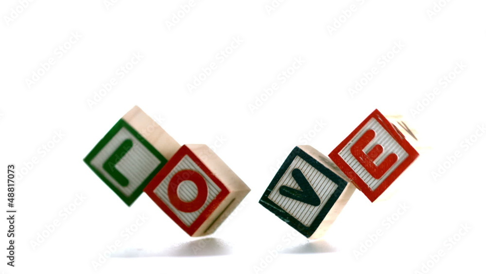 Building blocks spelling out love falling Building blocks spelling out love falling