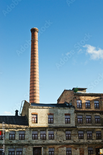 Smokestack towers over the old industrial building