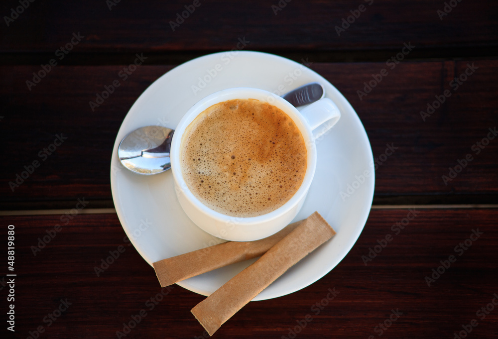 Obraz premium White porcelain cup of freshly brewed coffee with sugar
