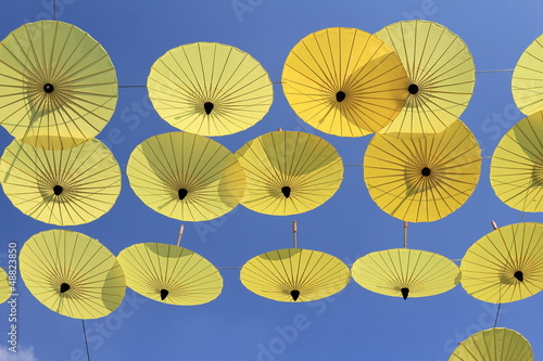 yellow umbrellas against a bright blue sky