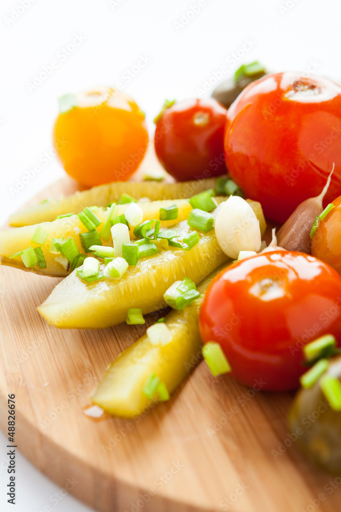 Pickled vegetables on a wooden board Pickled vegetables on a wooden board