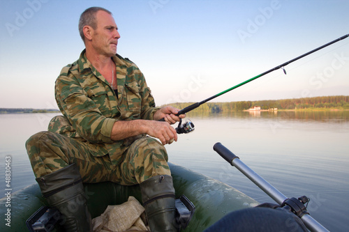 The man sit with a fishing tackle