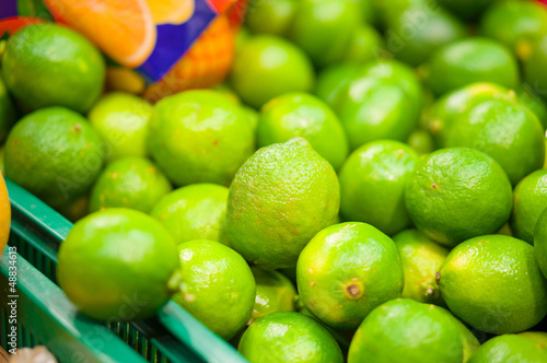 Bunch of limes in box in supermarket