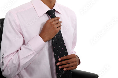 Businessman straightening his tie
