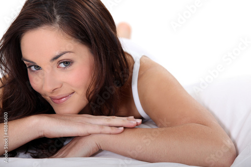 Smiling woman on a bed