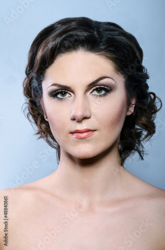 glamour woman with modern curly hairstyle and brightly makeup