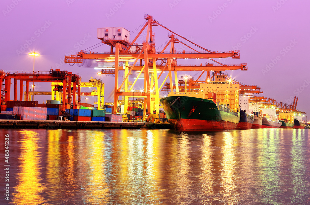 Naklejka premium Container Cargo freight ship with working crane bridge in shipya