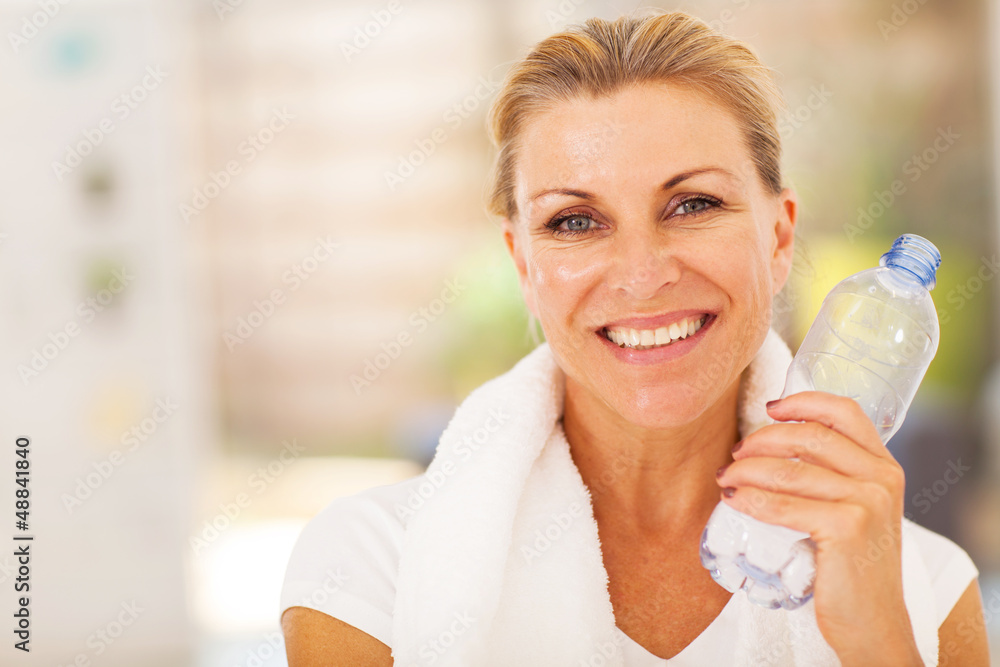 healthy senior woman with exercise towel and water healthy senior woman with exercise towel and water