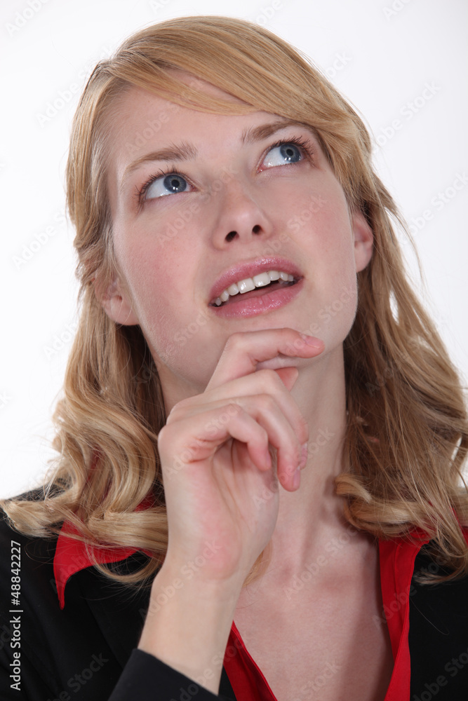 woman wondering and holding her chin woman wondering and holding her chin