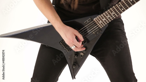 Metal musician playing electric guitar. Close-up.