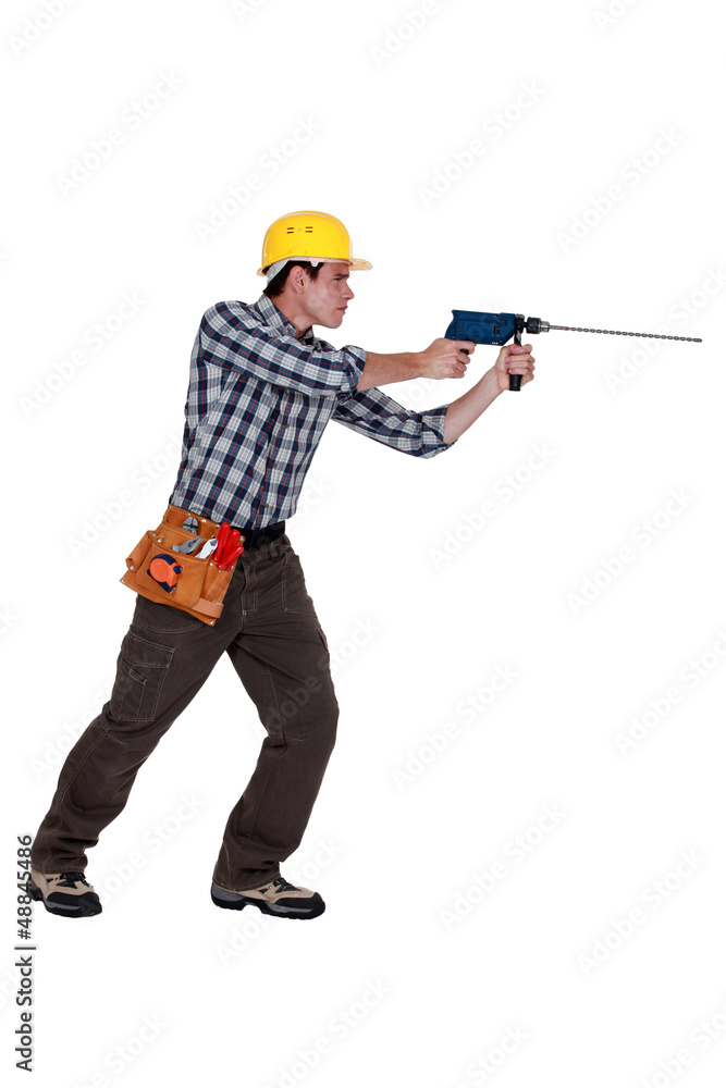Man using drill with long bit Man using drill with long bit