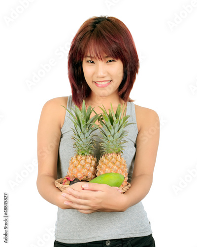 Isolated young asian woman with variety of oriental fruits.