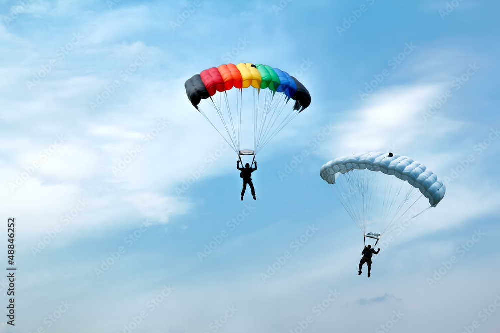 unidentified skydivers on blue sky - obrazy, fototapety, plakaty 