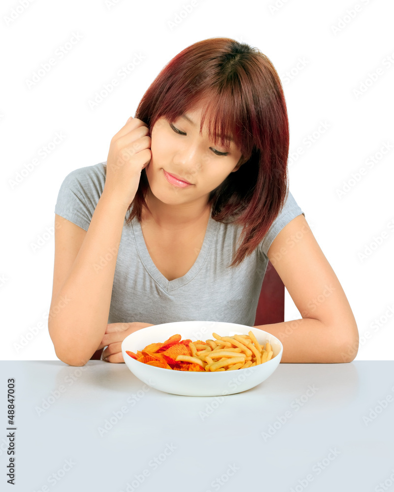 Isolated young asian woman with a plate of potato chips and fren Isolated young asian woman with a plate of potato chips and fren