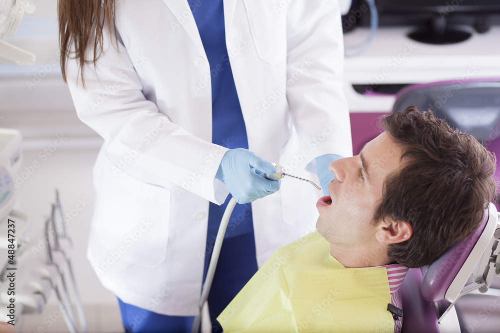 Fototapeta premium Female dentist working on a patient
