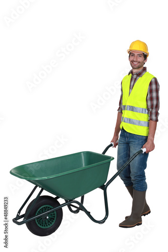 Billede på lærred craftsman pushing a wheelbarrow
