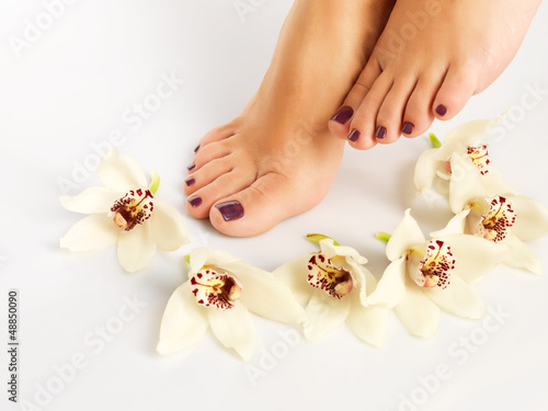 female feet with beautiful pedicure after spa procedure