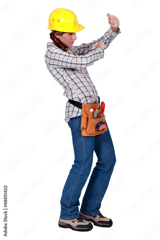 A female construction worker protecting her eyes. A female construction worker protecting her eyes.