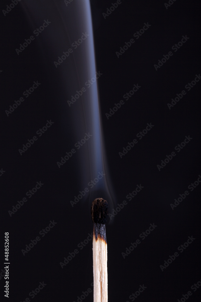 extinguished match with smoke on black background extinguished match with smoke on black background