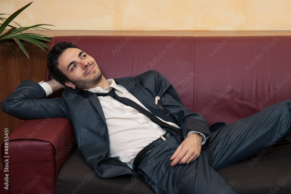 Fototapeta premium Young businessman relaxing on sofa.