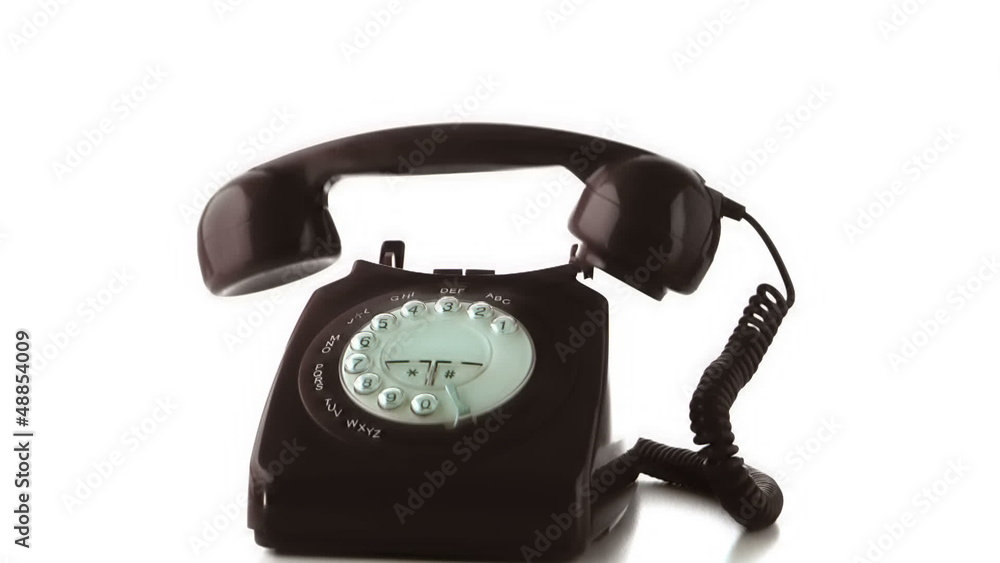 Receiver falling on black dial phone in slow motion Receiver falling on black dial phone in slow motion