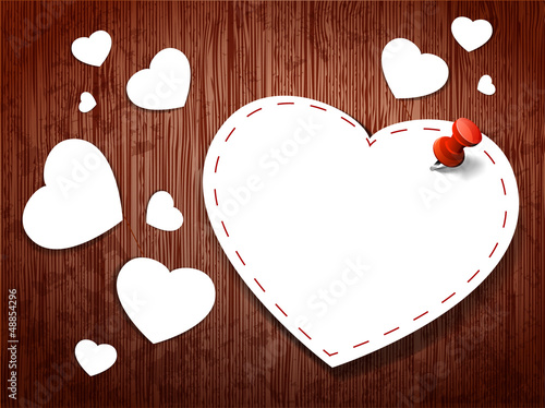 Paper hearts on a wooden background. Valentine`s day card.