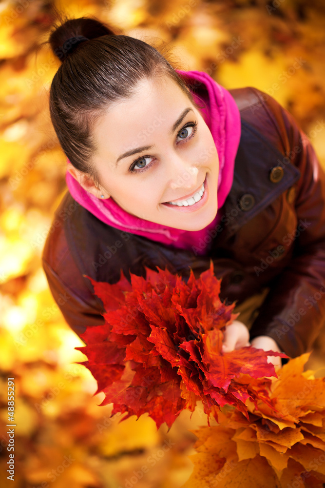 girl on a background of autumn leafs. top view girl on a background of autumn leafs. top view