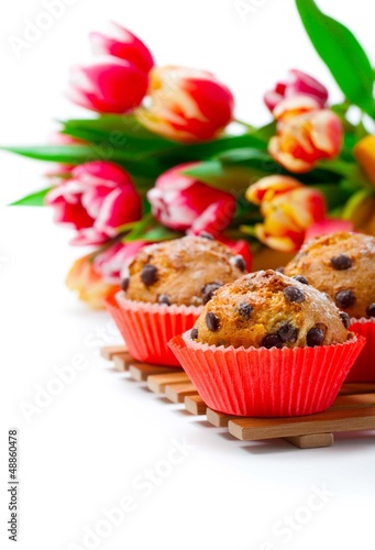 Muffins with tulips isolated on white background