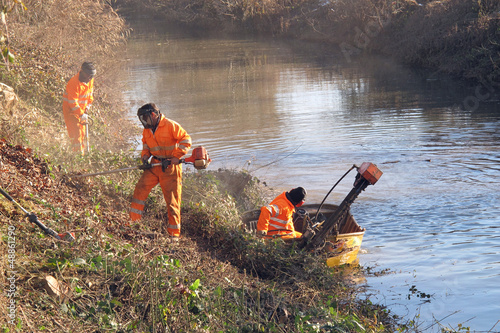 workers at work during cleanup of the banks of the River photo