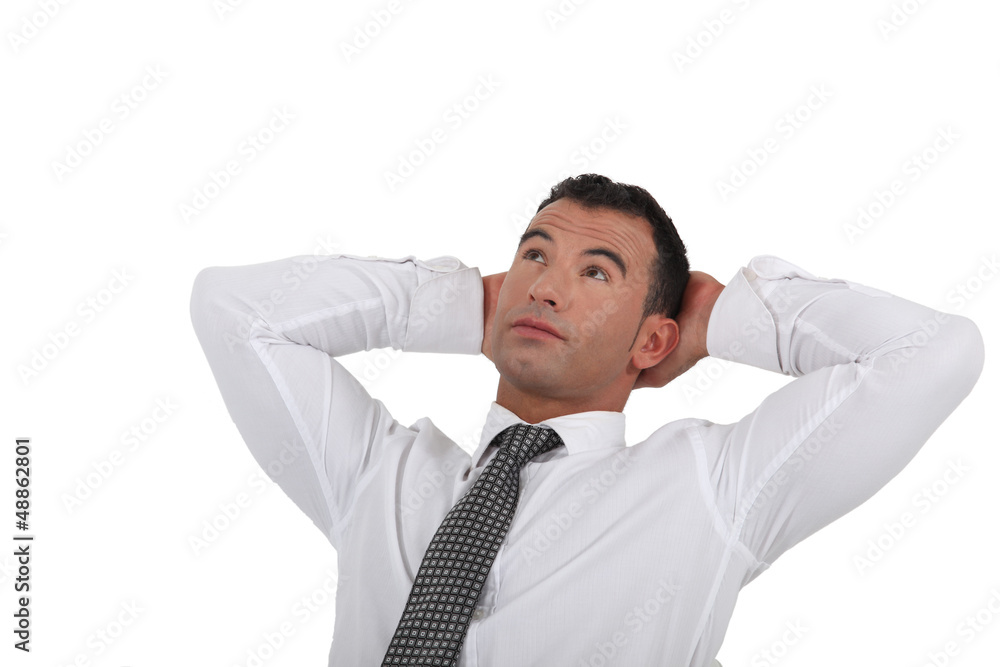 Businessman stretching his arms behind his head Businessman stretching his arms behind his head