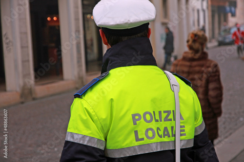 policeman in uniform of the municipal police in Italy during a s