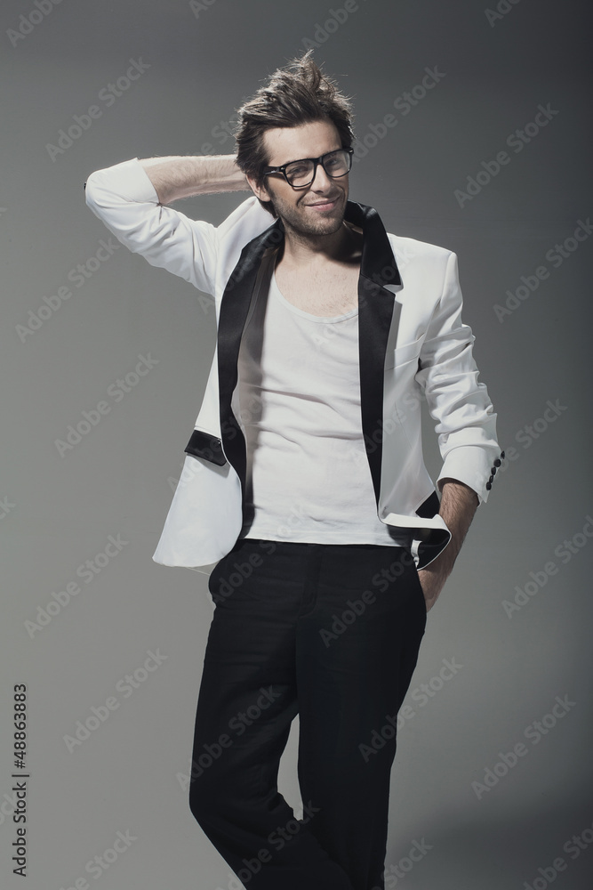 Handsome man casually leaning against the wall Handsome man casually leaning against the wall