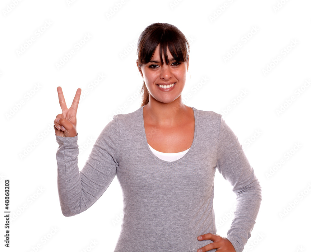 Adult woman smiling and showing you victory sign Adult woman smiling and showing you victory sign