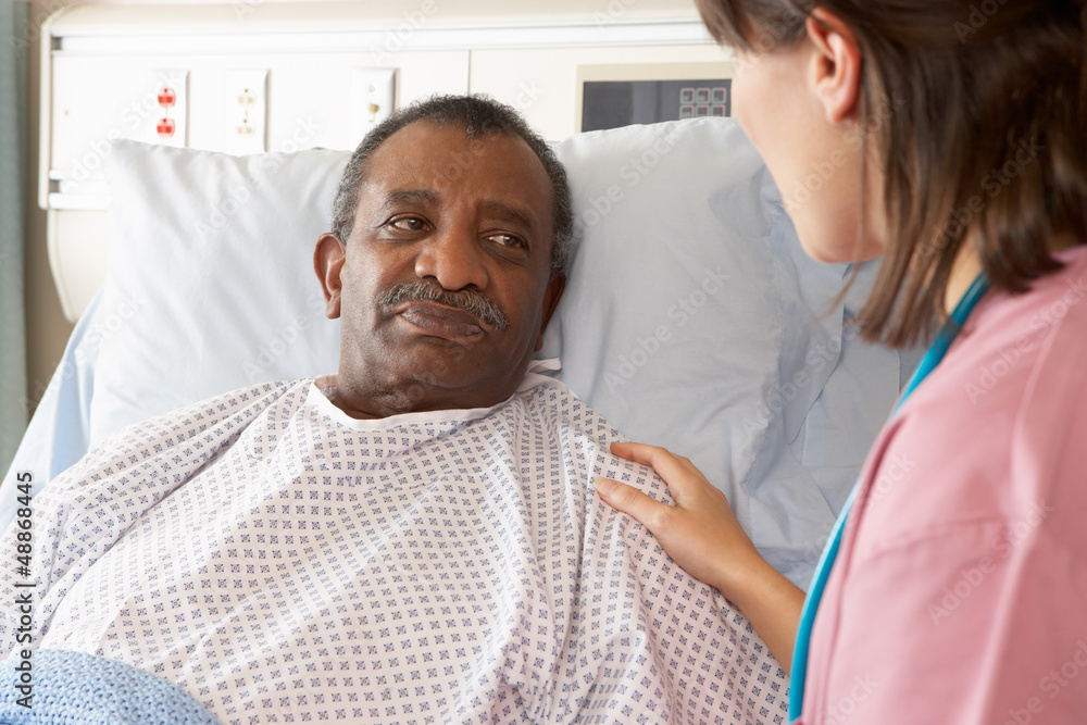 Nurse Talking To Senior Male Patient On Ward Nurse Talking To Senior Male Patient On Ward