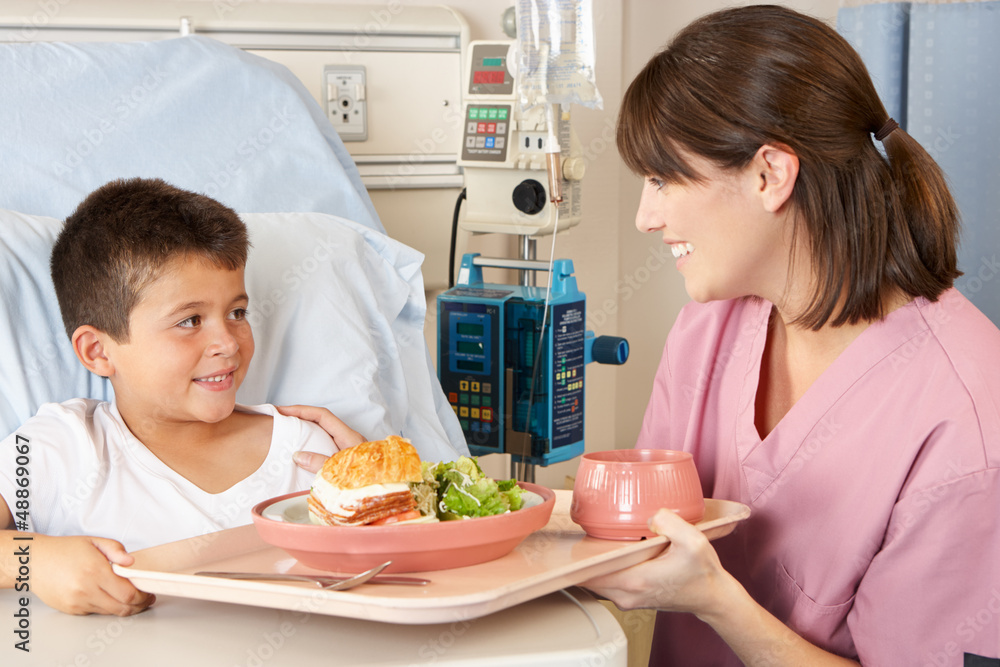 Nurse Serving Child Patient Meal In Hospital Bed Nurse Serving Child Patient Meal In Hospital Bed
