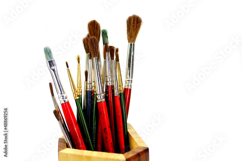 paint brushes in wooden stand