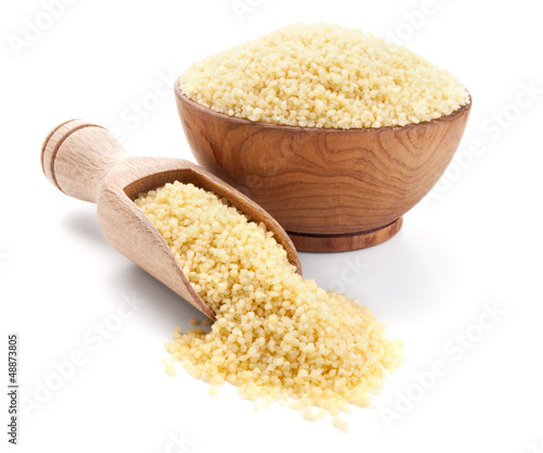 cuscus in a wooden bowl isolated on white