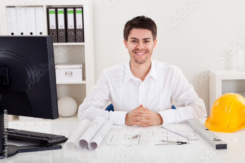Konstfotografi Confident young architect in his office