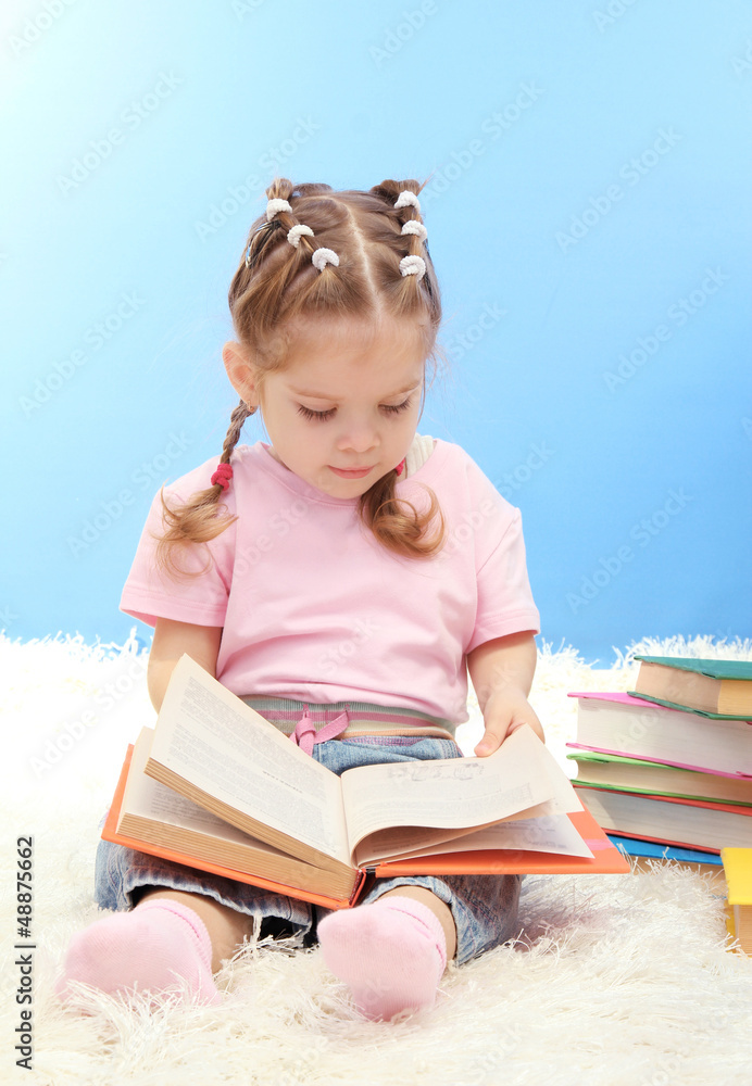 cute little girl with colorful books, on blue background cute little girl with colorful books, on blue background