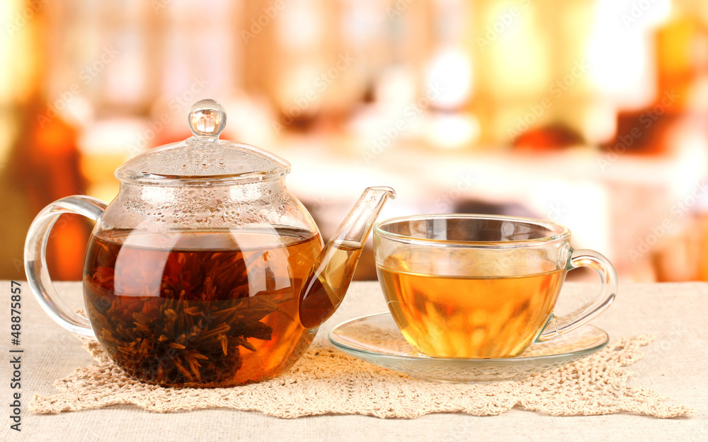 Exotic green tea with flowers in glass teapot Exotic green tea with flowers in glass teapot