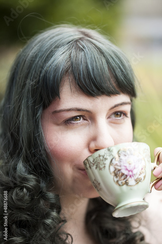 Young Woman with Antique Tea Cup