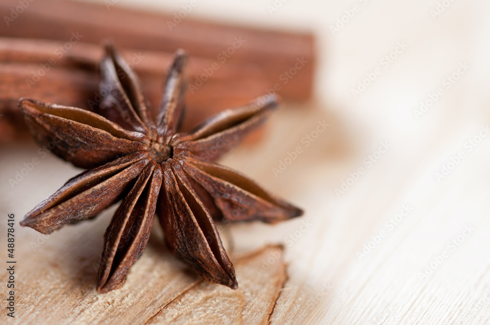 Macro shot of a star anise and cinnamon on a wooden background Macro shot of a star anise and cinnamon on a wooden background