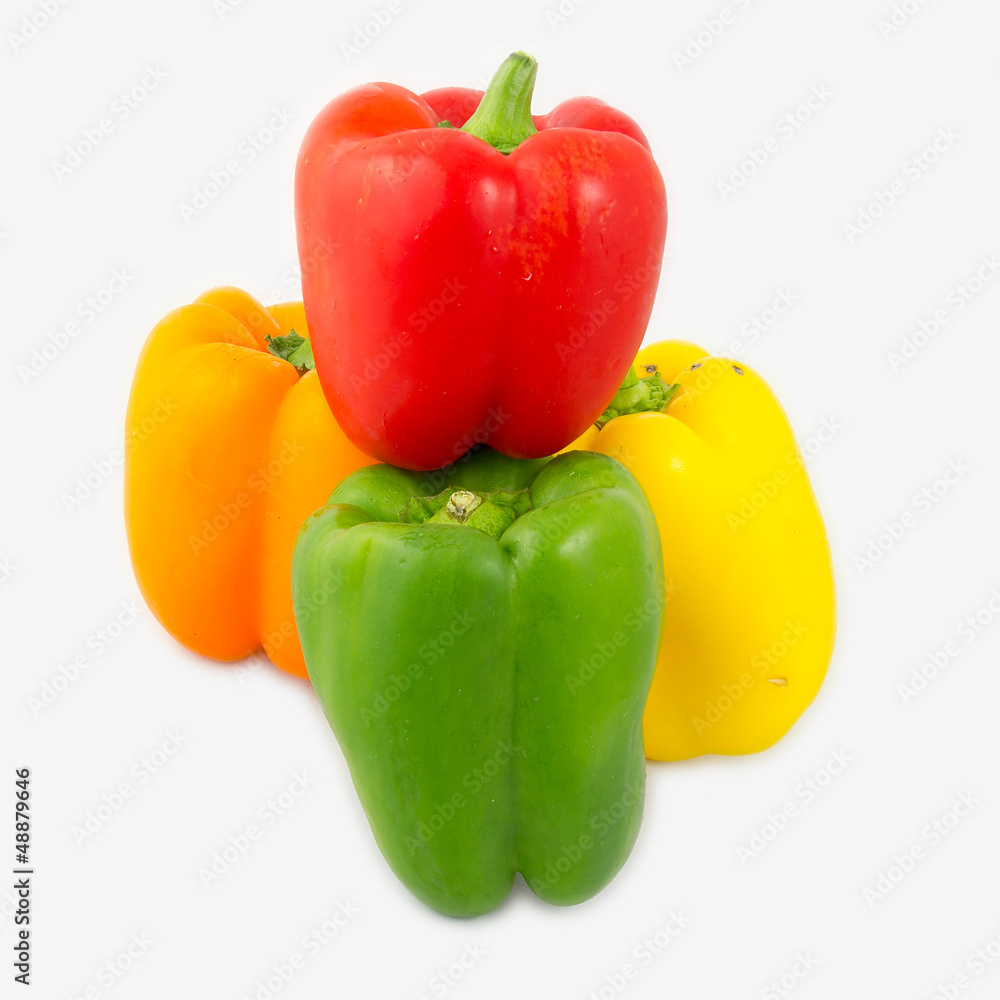A mix of differently colored bell peppers isolated on white back A mix of differently colored bell peppers isolated on white back