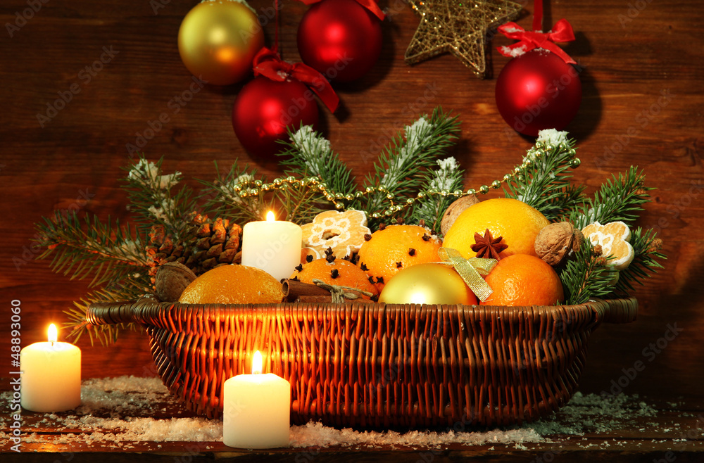christmas composition in basket with oranges and fir tree,