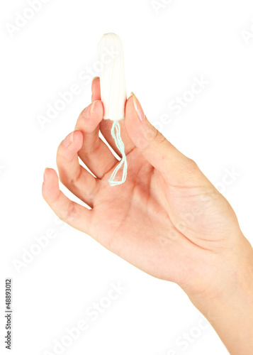 woman's hand holding a clean cotton tampon