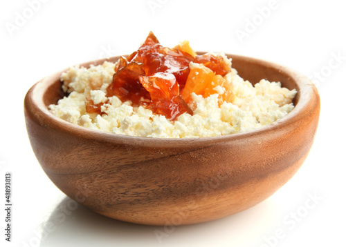 cottage cheese in wooden bowl with homemade tangerine jam,