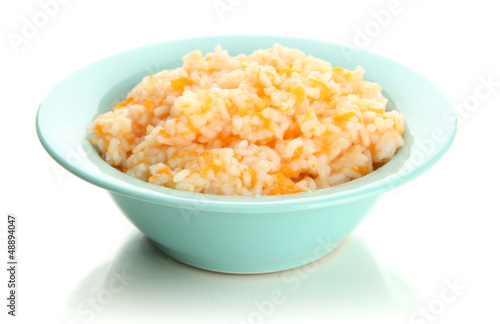 Taste rice porridge with pumpkin in blue bowl, isolated