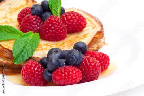 Delicious Freshly Prepared Pancakes with Honey and Berries