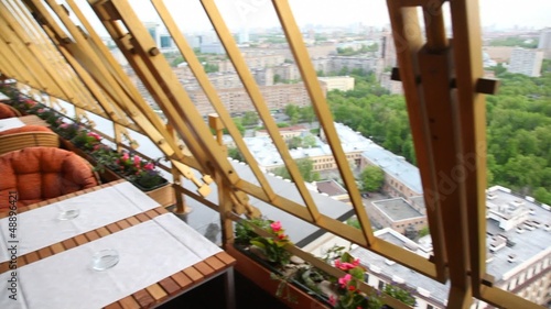 Tables stands on terrace whence central district of city