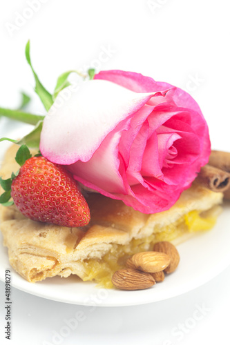 piece of apple pie, cinnamon, pink rose, almonds and strawberrie